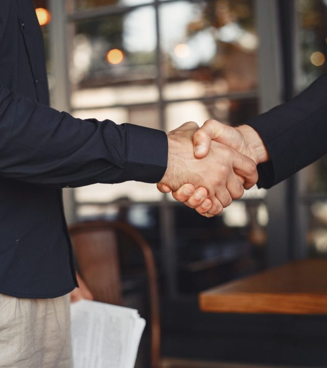 portrait of cheerful young manager handshake with new employee.